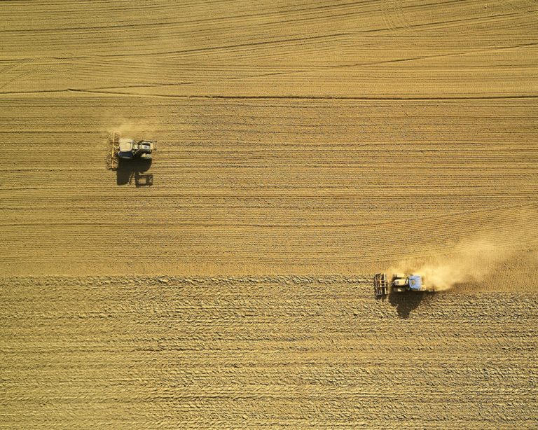 Aerial-view-from-drone-of-two-harvesters-by-Johny-Goerend-on-Unsplash.jpg