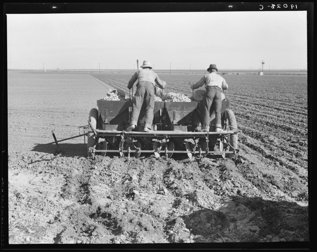Early mechanised farming by a crew of three men